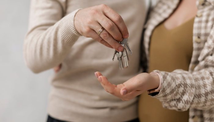 A Couple Holding the Keys for a New House